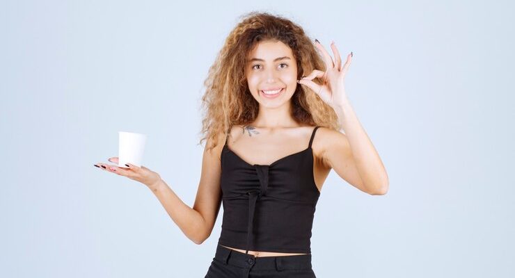 blondie-girl-holding-coffee-cup-showing-that-she-enjoyed-taste_144627-58447