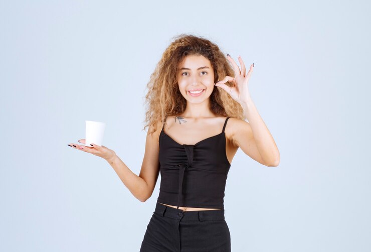 blondie-girl-holding-coffee-cup-showing-that-she-enjoyed-taste_144627-58447