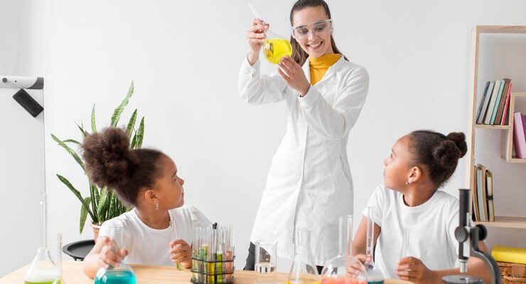 female-scientist-teaching-girls-chemistry-while-holding-tube_23-2148571269