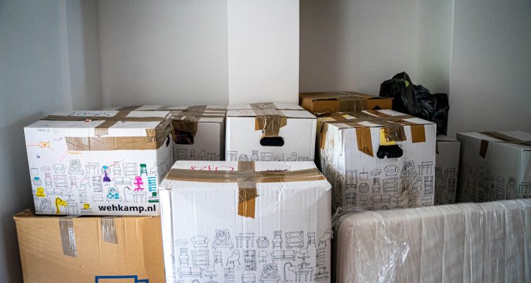 random-white-boxes-with-drawings-stacked-in-a-room