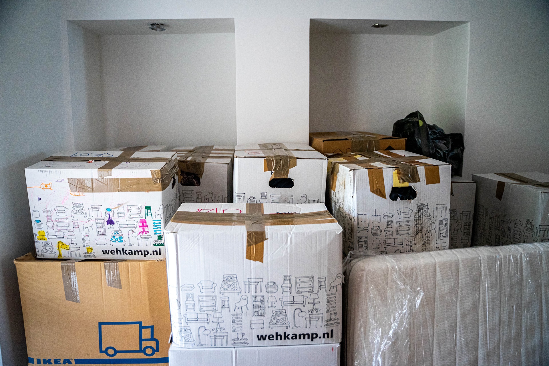 random-white-boxes-with-drawings-stacked-in-a-room